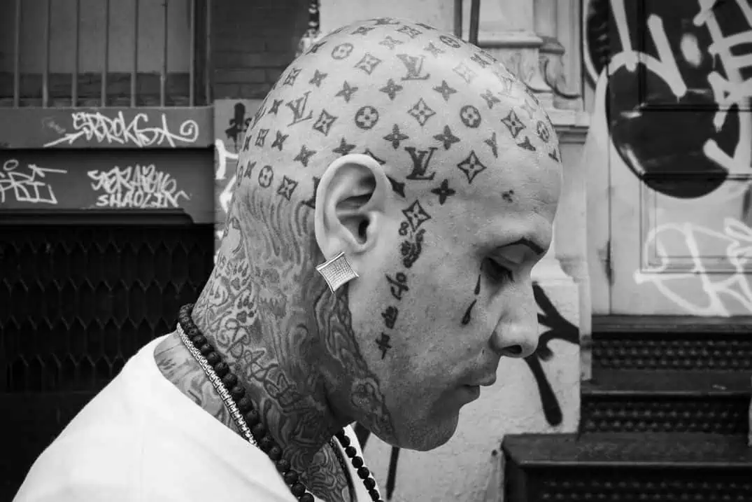 Street portrait print of man with Louis Vuitton tattooed on head, NYC street photo workshop